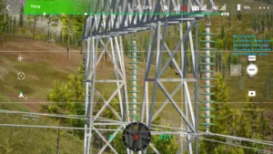 Drone simulator screenshot inspecting the middle phase insulator string of a 220kV linear tower