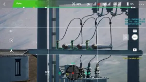 Lightning arrester on a 10kV double pole substation captured in drone simulation software.