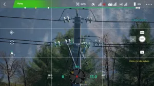 Right-side insulator of a 10kV tension pole captured in drone simulation for electric power operations.